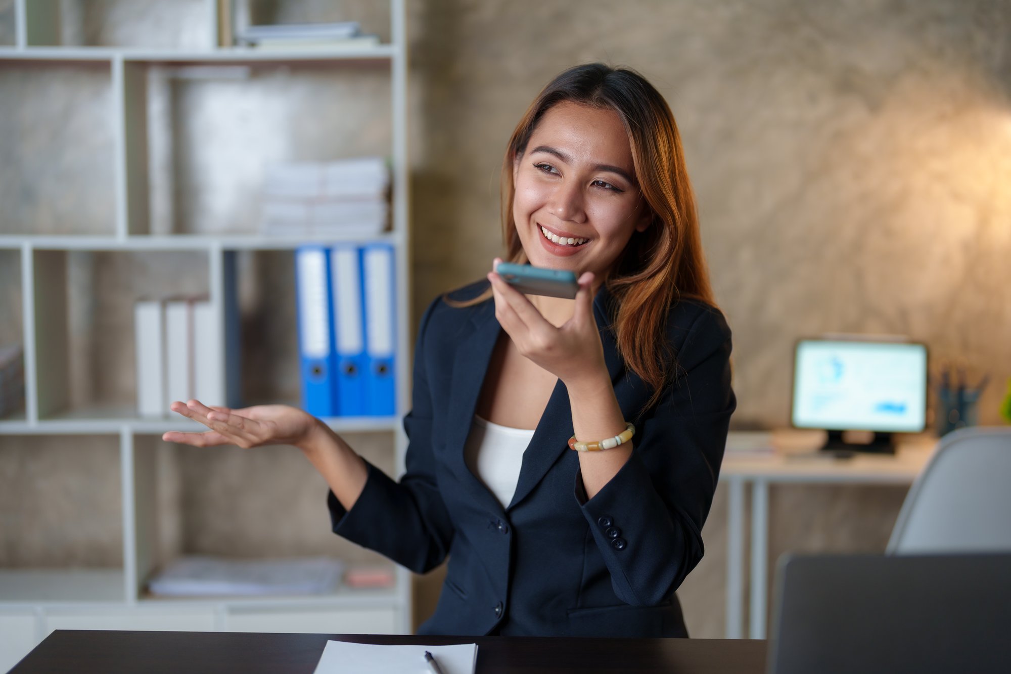 asian-businesswoman-sitting-happily-working-on-a-l-2023-02-21-18-46-15-utc